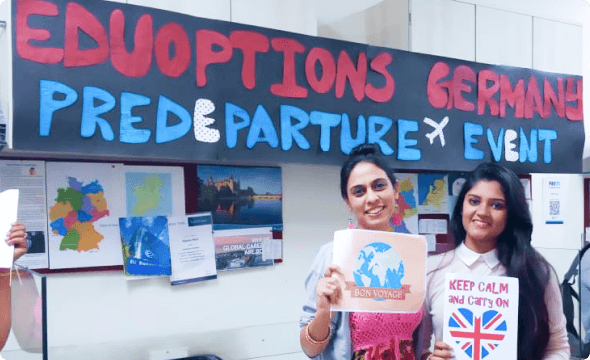 A counsellor and a student posing with posters at a pre-departure event at EduOptions’ Mumbai office.